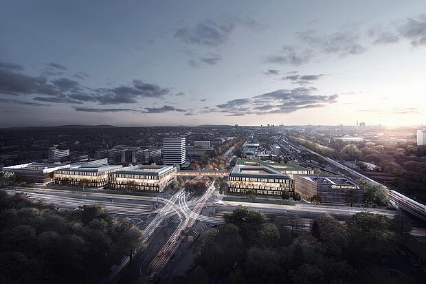 Eine moderne Stadtansicht mit zwei großen Gebäuden im Vordergrund, umgeben von Straßen und Bäumen. Im Hintergrund erstreckt sich die Stadtlandschaft unter einem bewölkten Himmel in der Dämmerung.